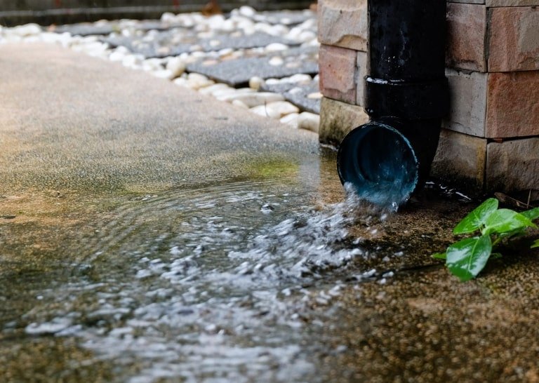 Water flowing through a gutter downspout