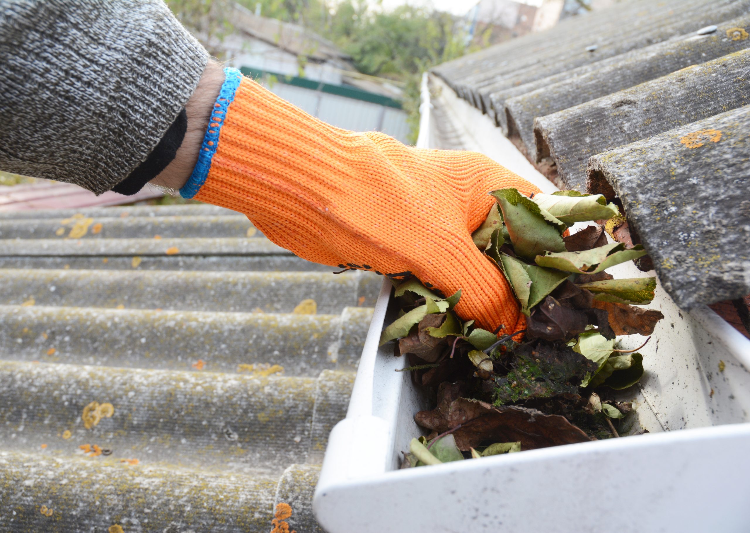 eavestrough maintenance- hand unclogging gutters