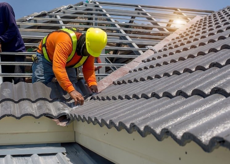 roofer in the middle of replacing roof shingles