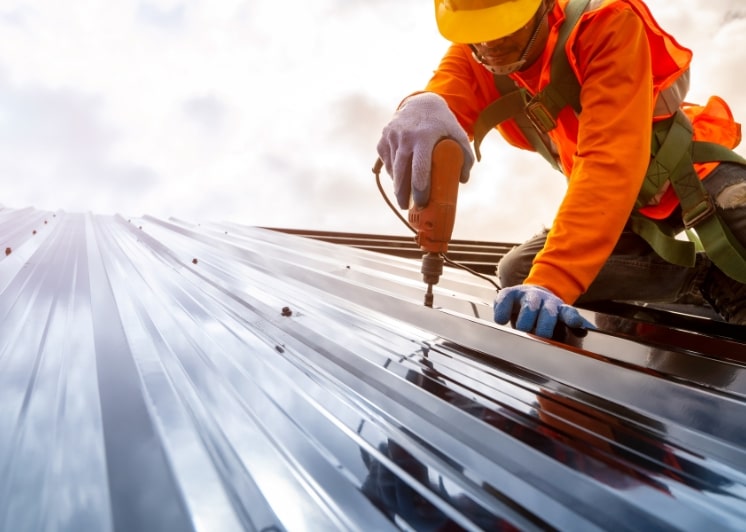 roofer installing roof panels